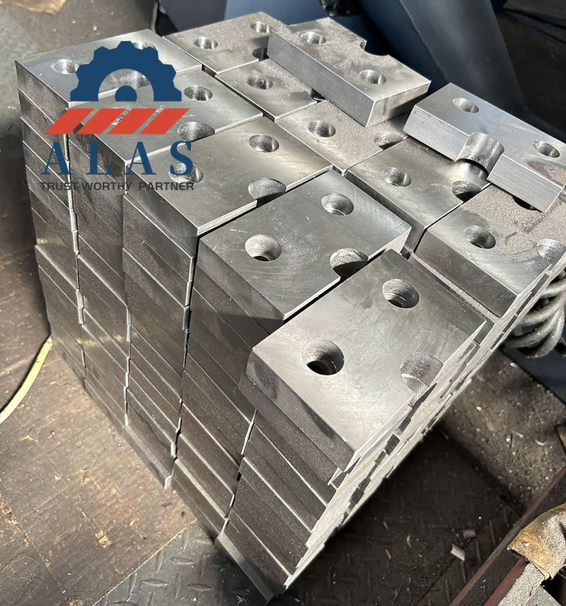 Wholesale Rebar Cutter Blades in Bulk Bulk supply of wholesale rebar shear blades and heavy-duty steel cutter blocks stacked in a factory workshop