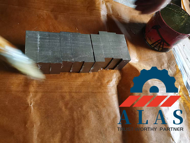 Professional Anti-Rust Export Packaging Process Workers applying anti-rust protective oil and wrapping finished industrial rebar cutter blades in professional moisture-proof kraft paper