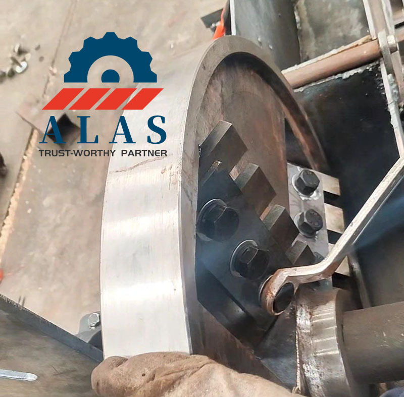 ALAS Premium A8 Steel Disc Chipper Blade Installation An operator tightening ALAS A8 steel disc wood chipper knives during blade replacement installation