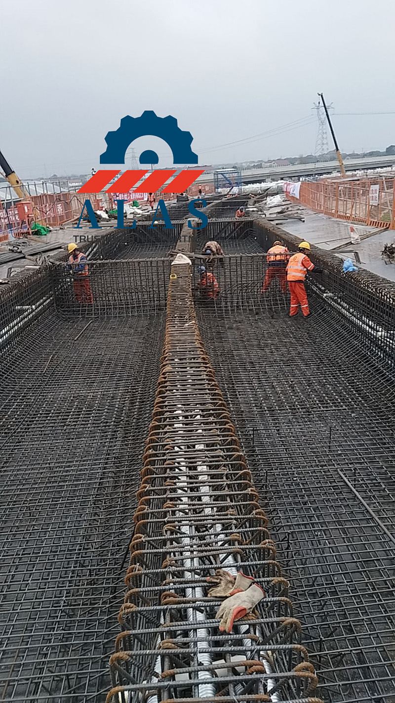Mega Project Reinforcement Steel Application A large scale infrastructure bridge construction site with workers installing a massive high strength heavy duty rebar reinforcement skeleton layout