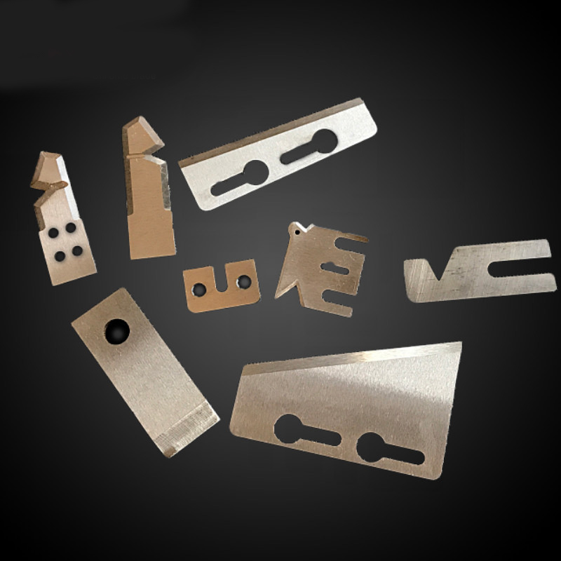 An assortment of industrial tire cutting blades and custom rubber cutter knives with various slot configurations and cutting edges