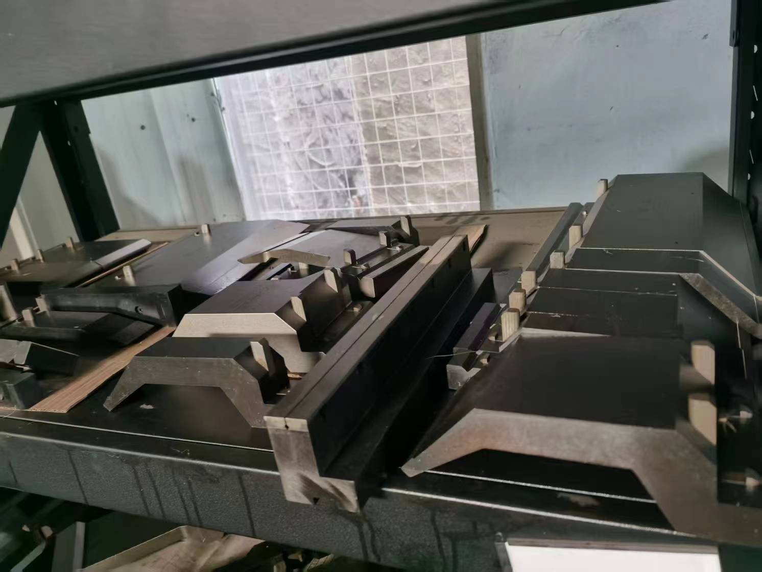 ALAS custom forming press brake tooling and specialized bending dies stack, engineered for complex sheet metal shapes