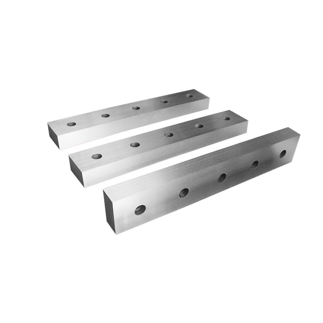 Industrial hydraulic scrap metal shear blades for alligator shears and container shears, made of high-impact H13 steel.