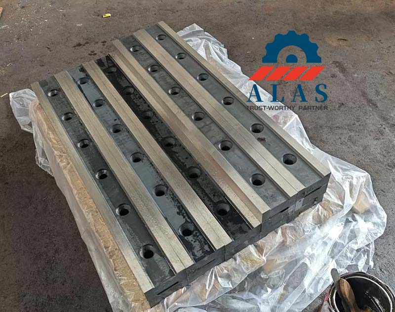 Finished custom alloy cold work steel alligator shear knives with precision countersunk bolt holes