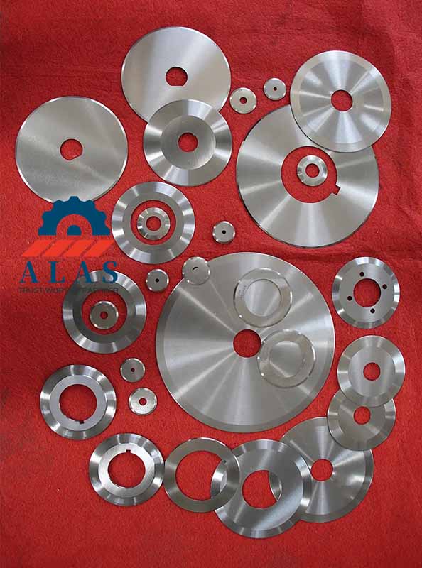 A collection of custom multi-size mirror-polished circular slitter knives with clear drive slots and keyways for adhesive tape converting lines.