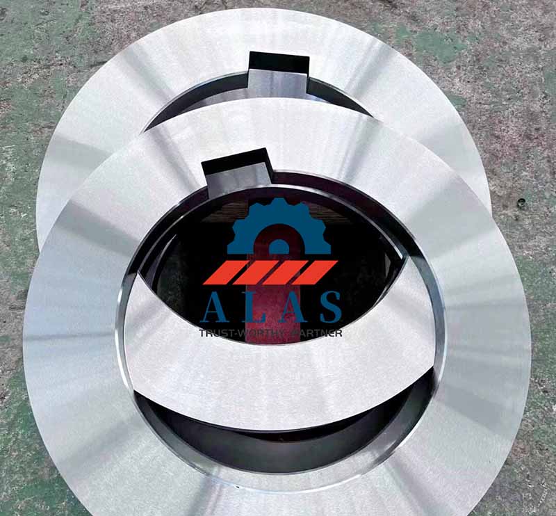 Two precision-ground alloy steel rotary slitter knives with internal keyways stacked to demonstrate parallelism.