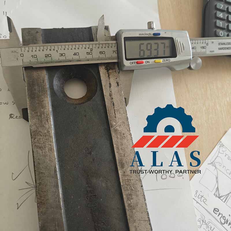 Measuring total width dimensions of an abrasive worn tool steel shear blade block showing 69.37mm