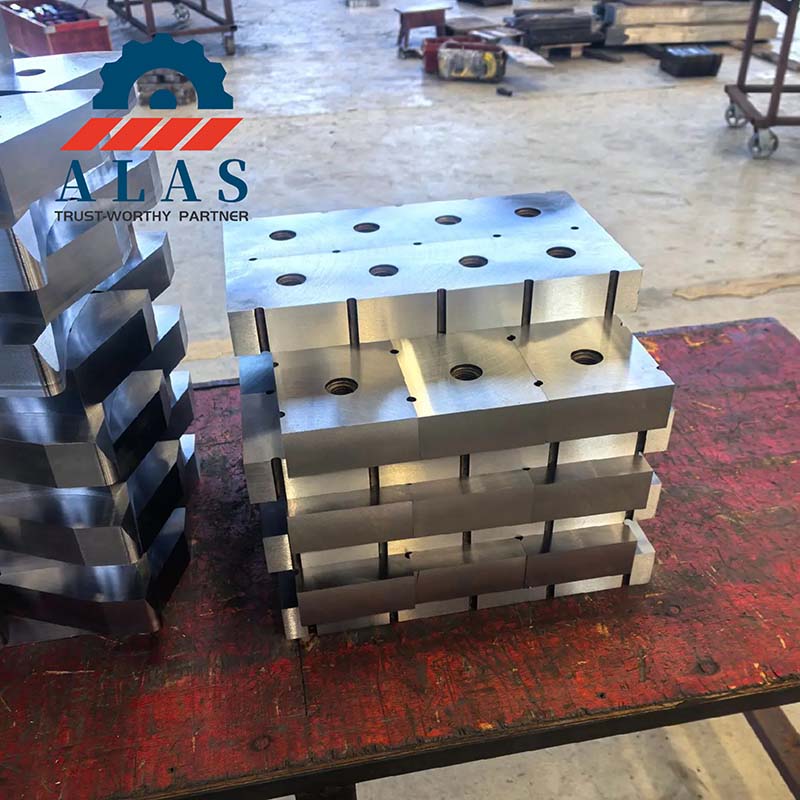CNC ground square mobile shear blocks and excavator shear guide blades on workshop workbench