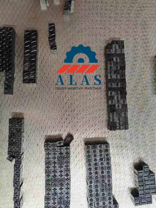 Rows of industrial metal marking punches arranged on a factory workshop table