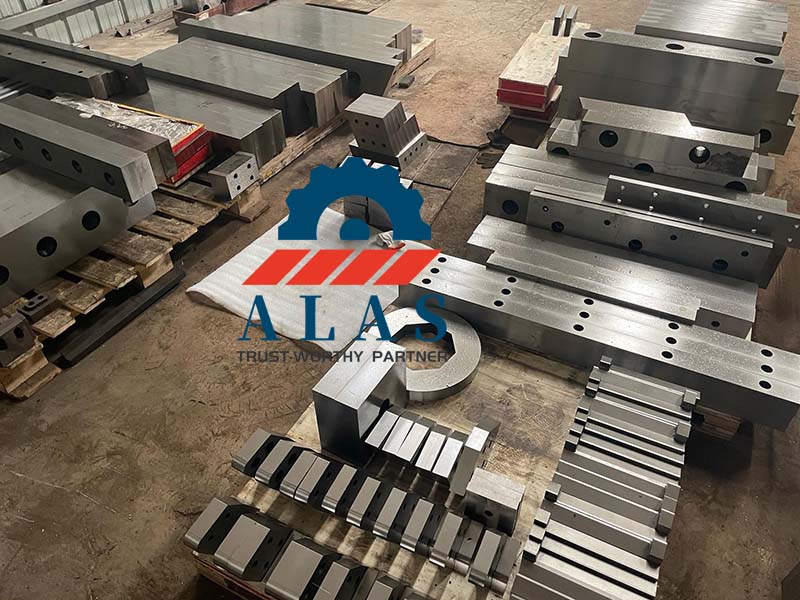 Batch inventory of heavy alloy tool steel custom alligator shear blades and blocks in factory machining workshop