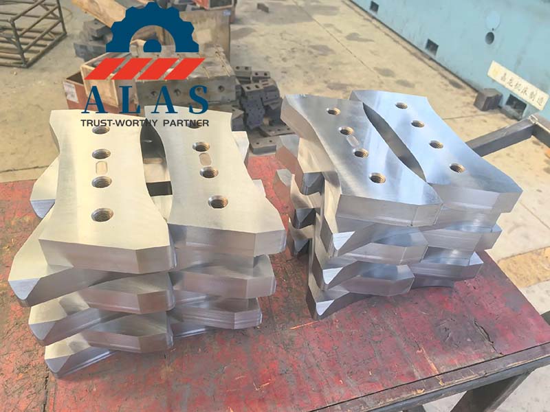 Finished mobile scrap shear upper jaw blades with multiple bolt holes after final dimension check