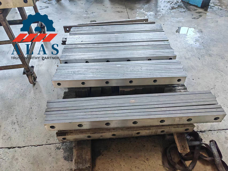 Finished metallic-gray straight cutting knives optimized for stainless sheet processing.