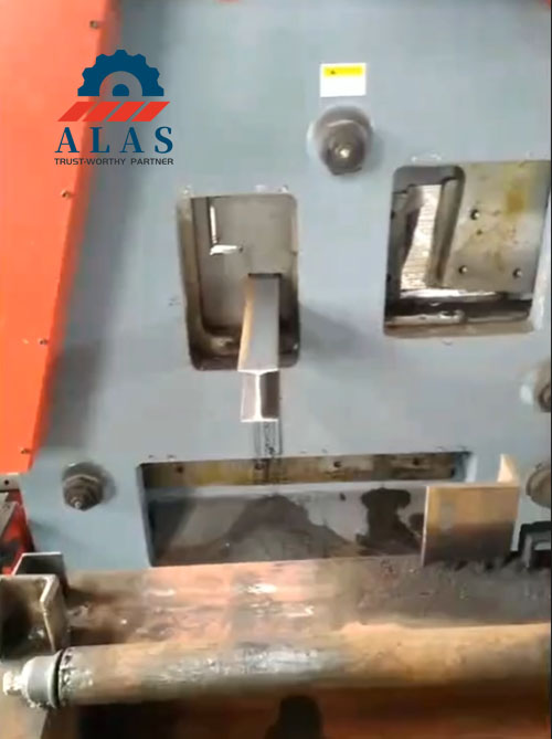 Industrial hydraulic ironworker machine performing angle steel profile cutting at section shear station
