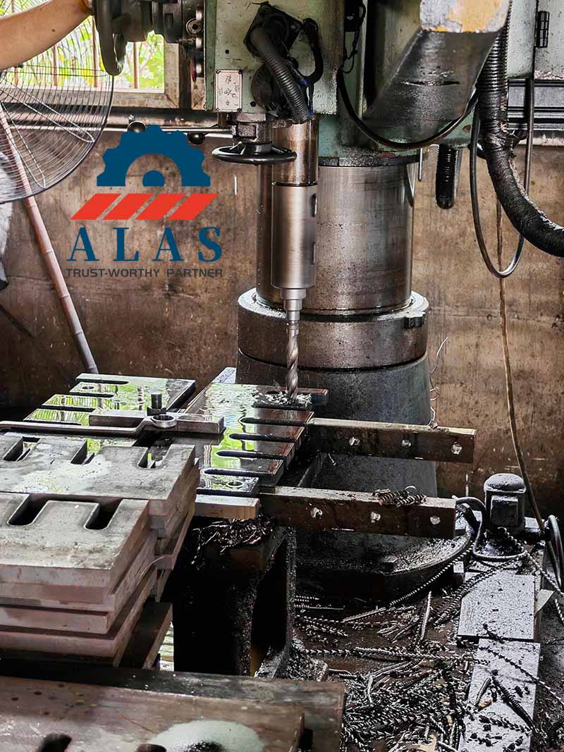 Heavy-duty radial drilling machine precision machining bolt holes on wood chipper counter knives at ALAS facility