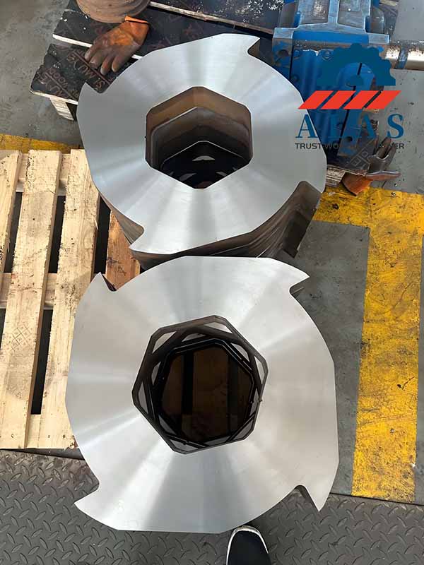 Two batches of finished tool steel RDF shredder knives resting on a workshop pallet, featuring controlled thickness and parallelism.