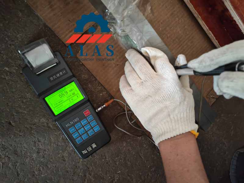 digital portable Leeb hardness tester verifying surface hardness consistency on alloy steel custom shear blade
