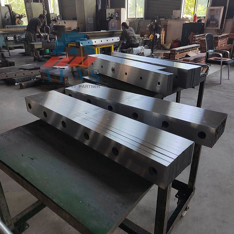 Vacuum heat-treated tool steel knives lined up for multidimensional inspection.