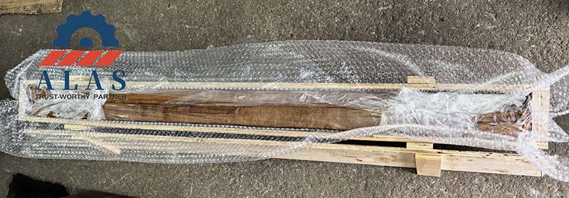 Finished linear knives wrapped in multi-layer protective film inside reinforced wooden cases.