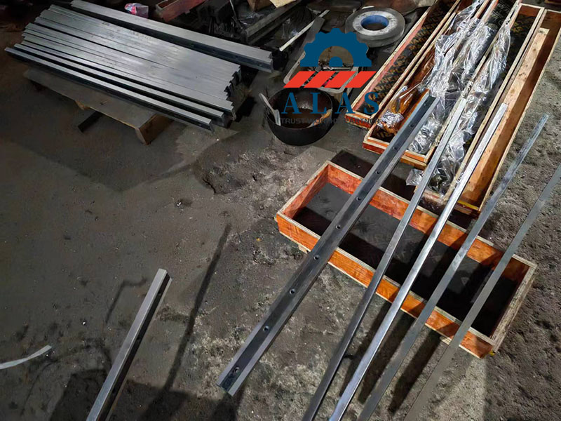 Finished industrial shear blades and guillotine knives manufactured from 9CrSi material, ready for delivery.