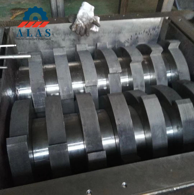 Heavy duty dual shaft shredder blades assembly on industrial recycling machine shafts