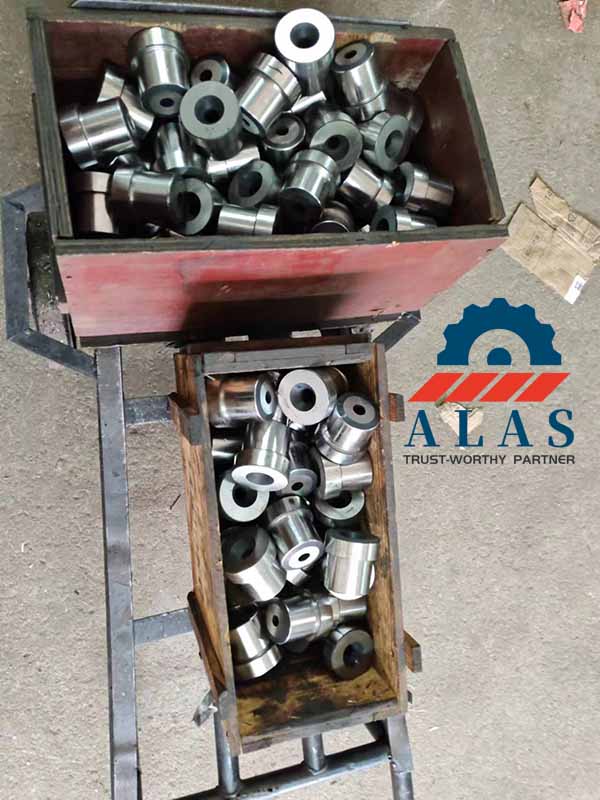 Bulk production run of finished AISI D2 fixed cutting blades in transfer crates for warehouse storage.
