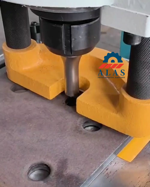 Heavy duty stripper plate and punch tool pressing on a steel plate in a ironworker