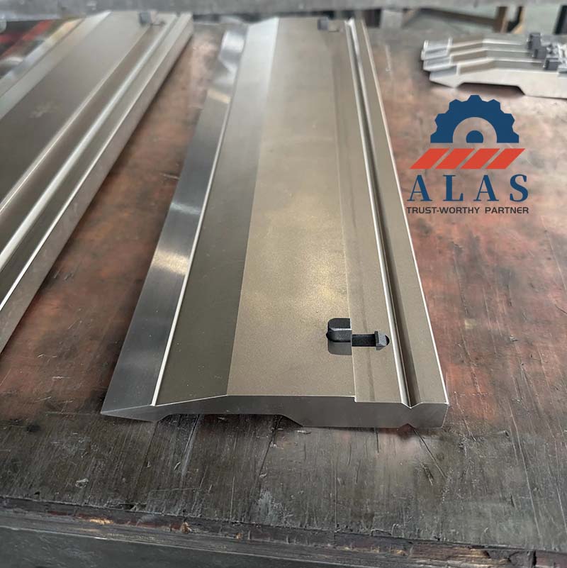 Close-up view of the precision ground mounting tang and quick-change safety click button on ALAS upper tool