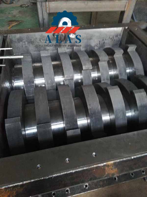 Pre-assembled intermeshing double shaft solid waste shredder blade stack mounted inside the cutting chamber.