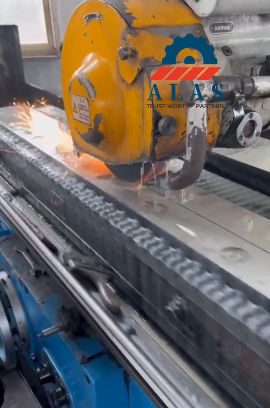Long-bed CNC grinding machine finishing the linear cutting edge of a heavy tool steel knife.