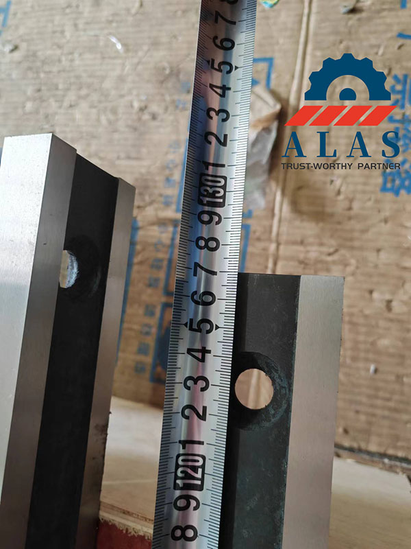 Close-up of measuring bolt hole center distances and counterbore depth on an linear cutting component