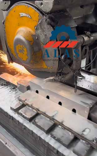 CNC automatic surface grinding machine sharpening the bevel edge of a specialized tool steel PET bottle granulator knife with flood coolant.