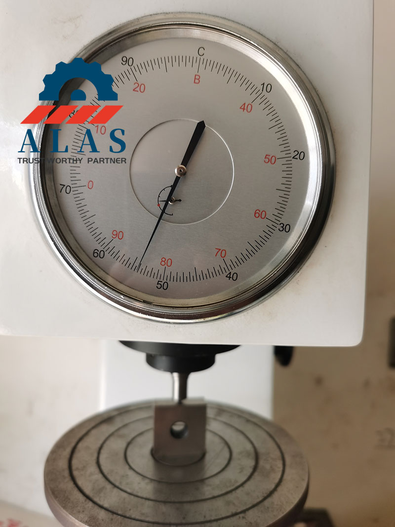 Rockwell hardness testing of a tool steel rebar cutter blade to verify HRC specification in QC lab