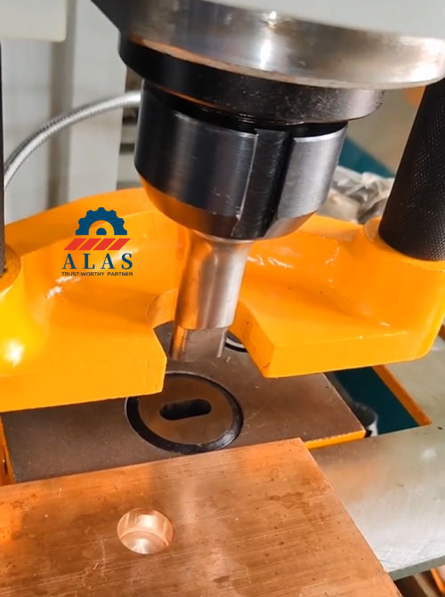 ALAS Heavy Duty Punches and Dies in Action Close up of a hydraulic ironworker machine executing slot punching with ALAS oblong die