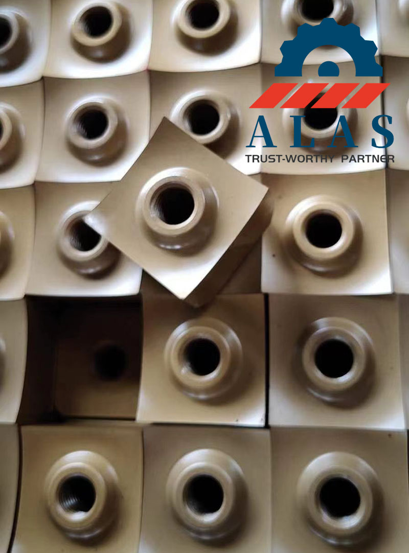 Row of square single shaft shredder blades with counterbore center holes and curved edges for wood and plastic recycling