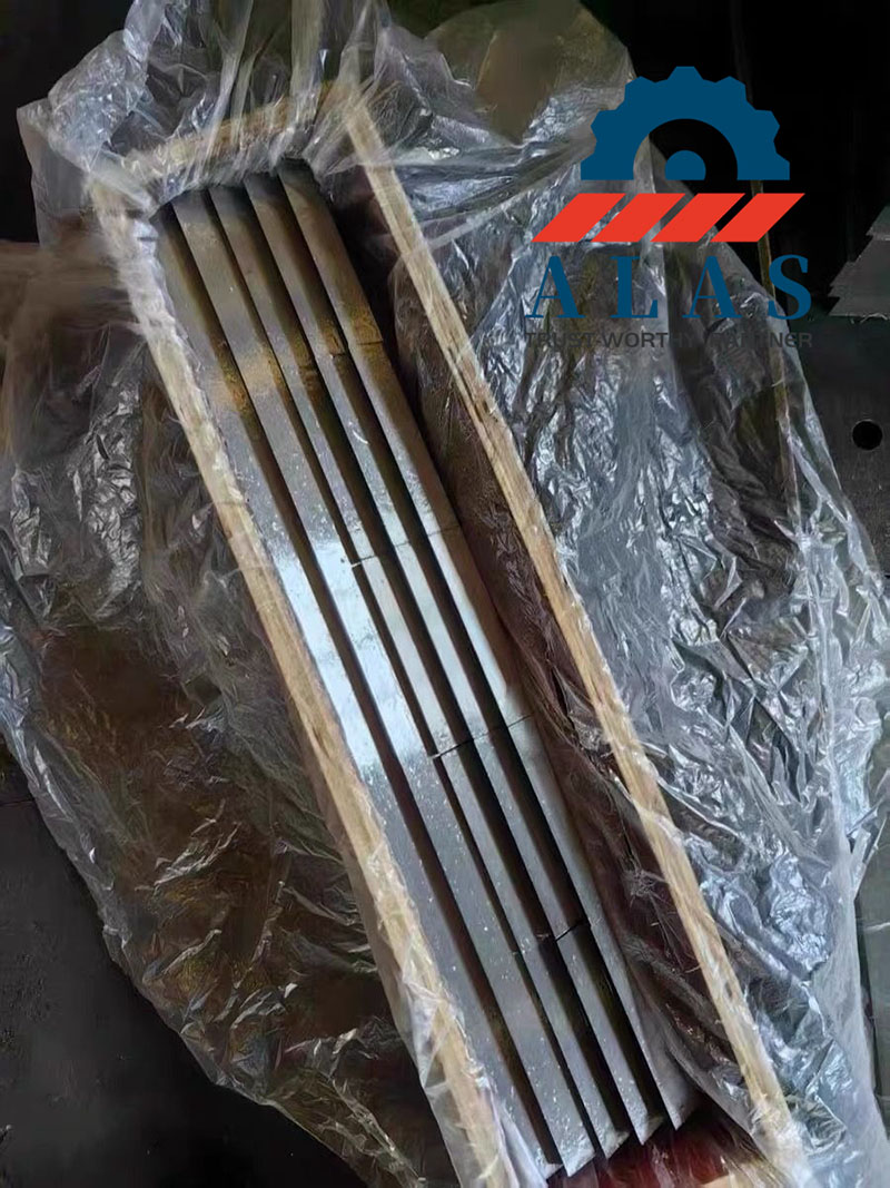 Long-strip plastic crusher blades and granulator knives packed in a seaworthy export wooden box with waterproof wrapping by ALAS Machinery.