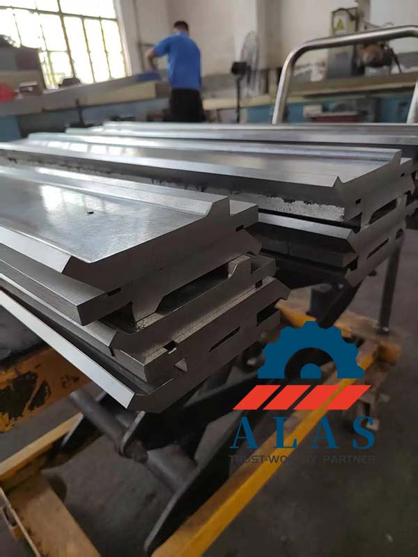 Heavy duty straight press brake punches stacked neatly in precision finishing line