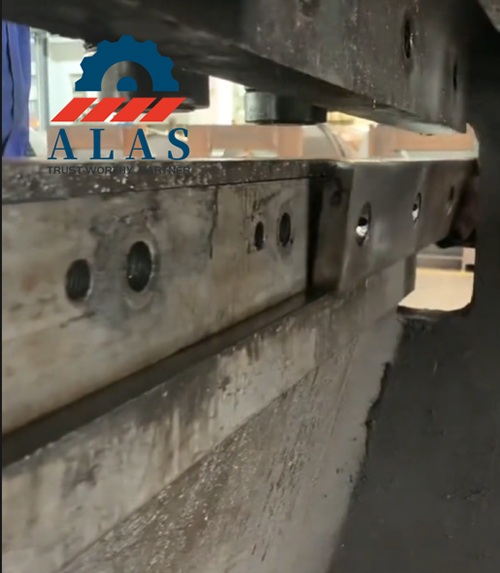 Segmented industrial shear knives seated inside the machinery metal blade pocket bed