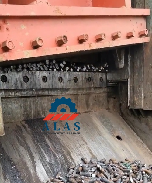Heavy duty hydraulic gantry scrap shear machine processing a high density bundle of high strength deformed rebar steel bars