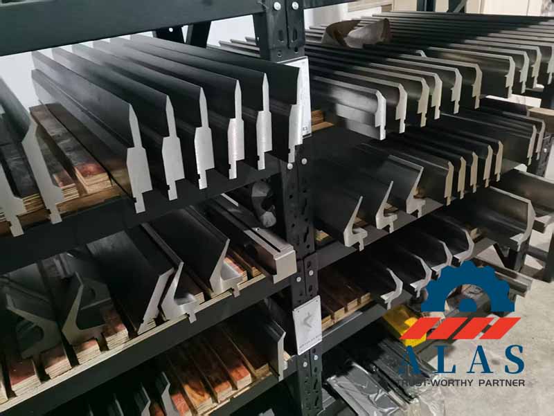 A heavy-duty storage rack stacked with hardened acute angle press brake punches and custom sharp-angle bending tooling.