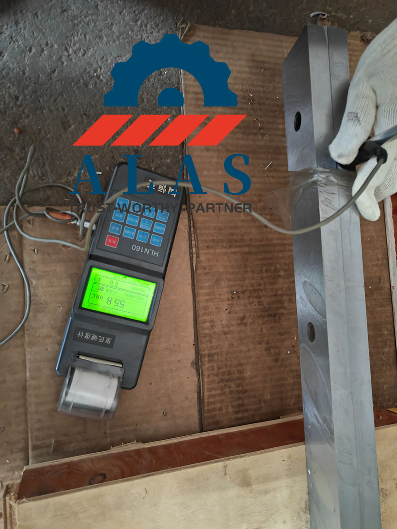 ALAS Shearing Blades Fixed Hardness Inspection ALAS vacuum heat-treated metal shear blades undergoing HRC hardness testing with a digital Rockwell tester