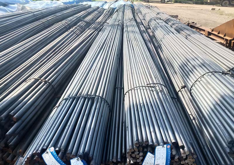 Bundles of traceable structural steel rebar with official material identification tags on site