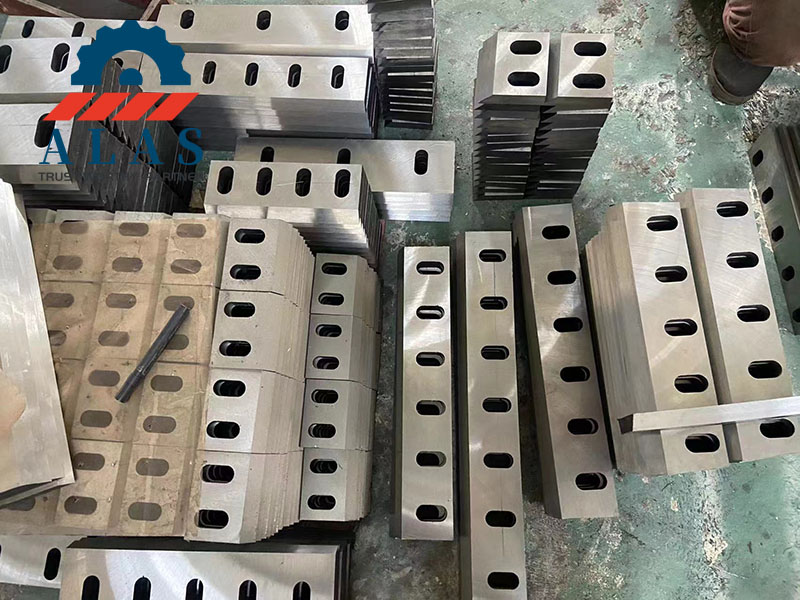 Batch of heavy-duty industrial plastic crusher blades and granulator knives stacked in the factory warehouse