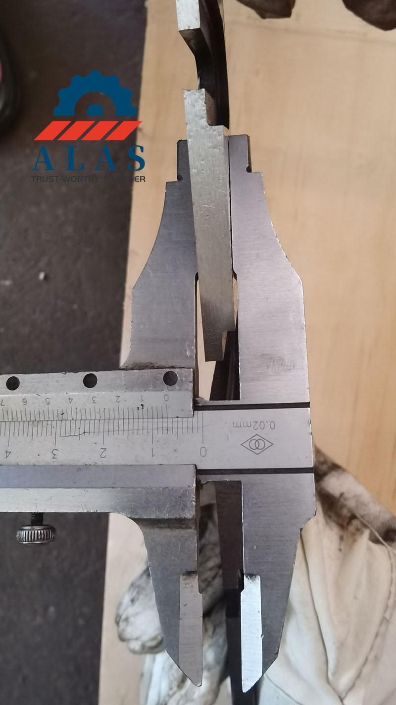 ALAS inspector measuring blade thickness with a vernier caliper to ensure 0.02mm strict tolerance