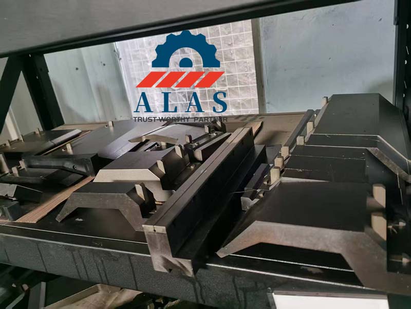 ALAS CNC precision single and double V dies sorted neatly on industrial shelving units inside a B2B warehouse.
