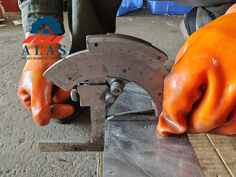 Quality inspector uses a bevel protractor to measure a custom shear blade angle.
