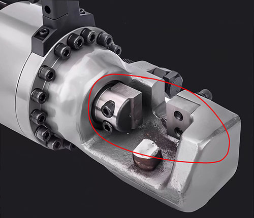 Replacement D2 steel rebar cutter blades locked inside electro-hydraulic tool head counterbores
